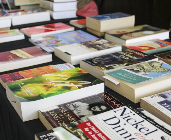 Series of books banned throughout the decades displayed on a table.